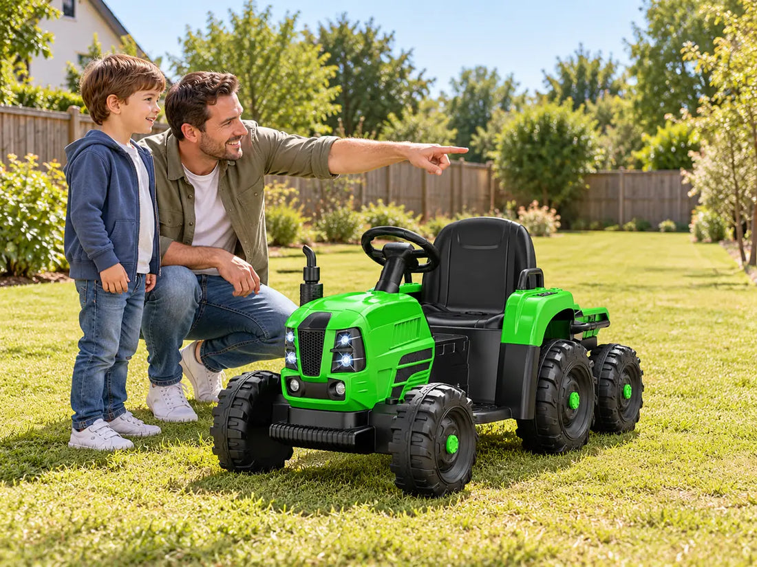 Parent and child checking a short dry grass route beside a green six-wheel ride-on tractor