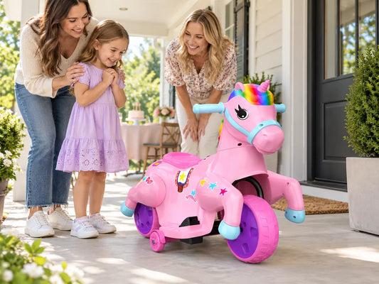 Family welcoming a child to the exact pink Akeleo electric unicorn ride-on at a calm birthday handoff