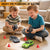 Two children playing with Akeleo RC drift cars at home, enjoying indoor racing fun with remote-controlled vehicles and traffic cones.